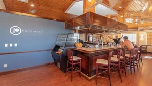 A restaurant with a bar area, wooden ceiling, and a logo on the wall. - Dbl Master |Oceanview |Jacuzzi |Beach |Marina |BBQ (Tavernier)