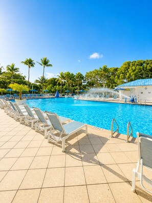 A swimming pool with lounge chairs and palm trees. - Dbl Master |Oceanview |Jacuzzi |Beach |Marina |BBQ (Tavernier)
