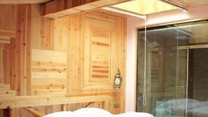 A wooden room with a bed, a window, and a wall-mounted lamp. - Panorama House Hotel (Guilin)