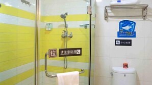 A bathroom with yellow and white tiled walls, a glass shower enclosure, a towel rack, and a toilet with a soap dispenser. - 7 Days Inn Suqian Fazhan Avenue (Suqian)