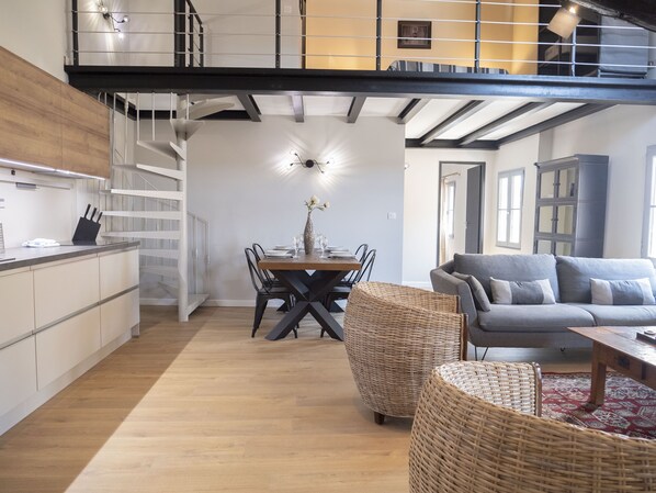 A modern interior with a dining area, kitchen, and living space.