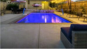 A swimming pool with a covered patio area, outdoor seating, and string lights. - TOBIN HILL OASIS - PRIVATE POOL HOUSE 3BD/2.5BA, SCREENED IN PORCH, FULL KITCHEN (San Antonio)