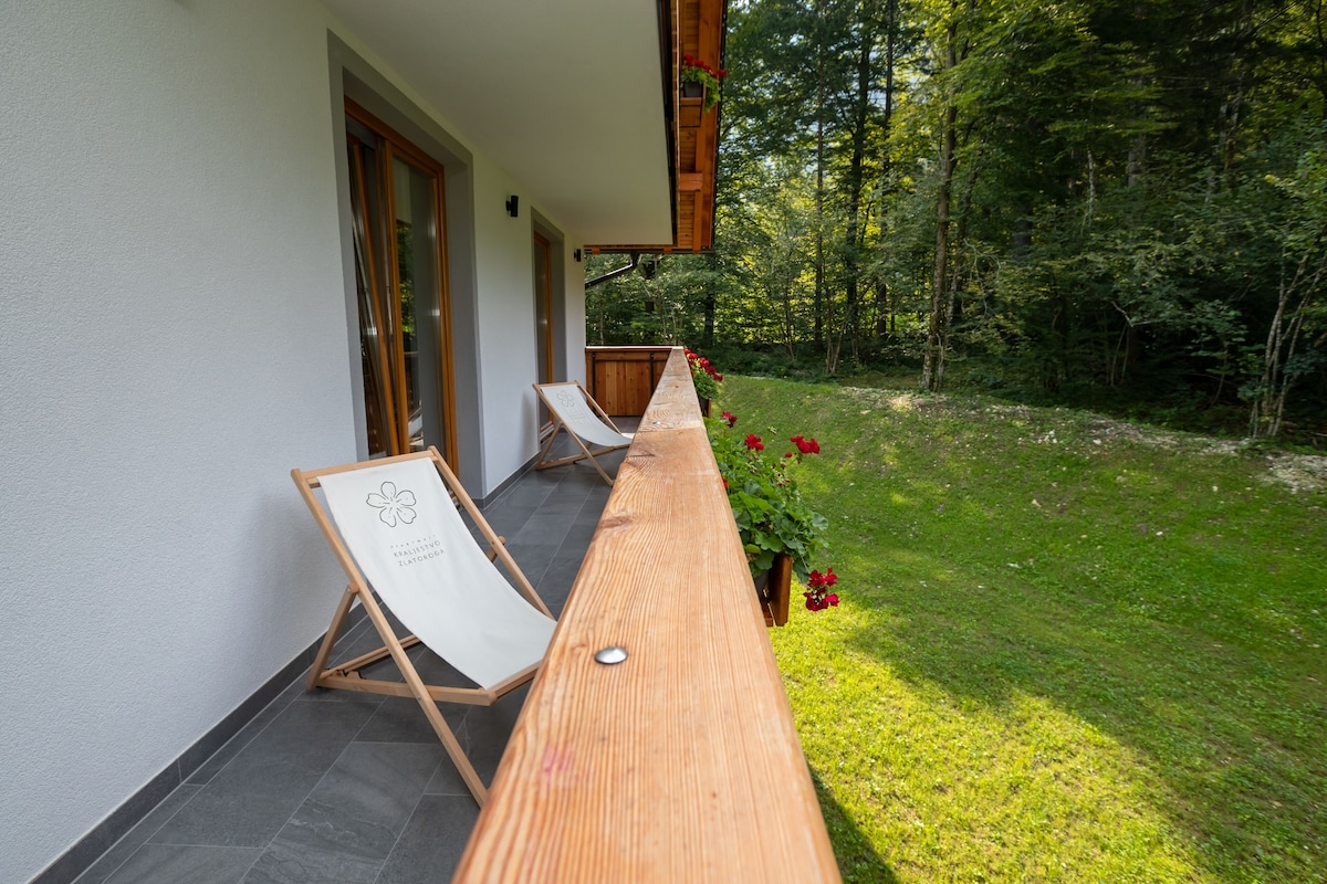 A wooden bench with a white canvas in a garden area.