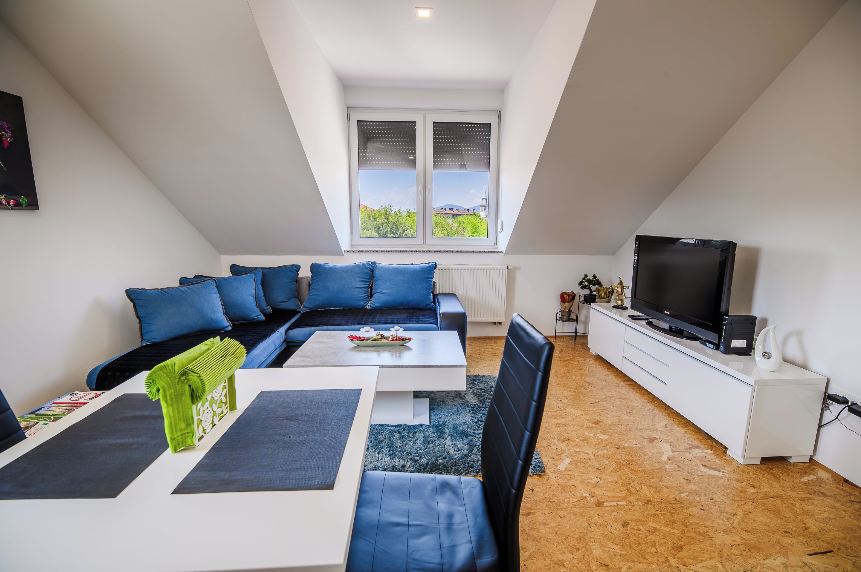 Una sala de estar moderna con un sofá, una mesa de centro y una televisión.