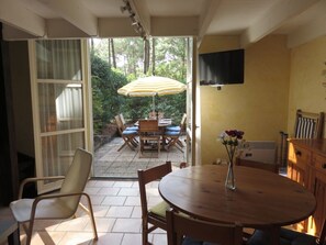 Relax in this serene room with a patio, featuring a dining table and comfortable seating.
