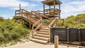A wooden staircase leading to a lookout tower with a metal railing. - April's Retreat - Oceanfront! Special rates for July 4-11! (Atlantic Beach)