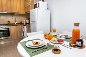 Enjoy a home-cooked meal in this fully equipped kitchen with a dining table set for two.