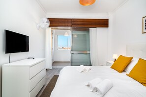 Relax in a spacious room with a large bed, flat-screen TV, and city views.