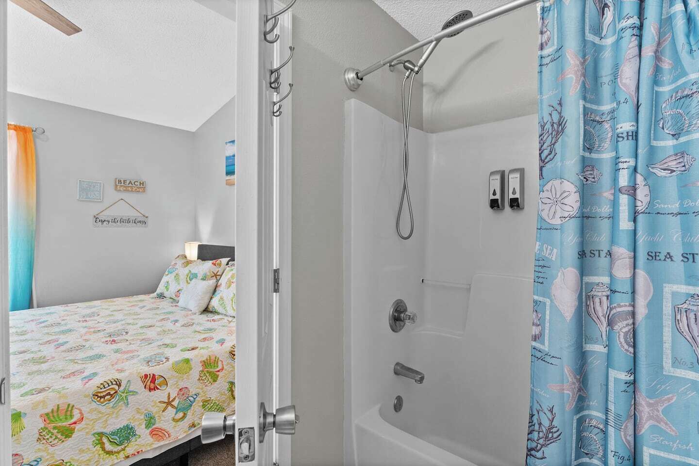 A bedroom with a bed, a shower, and a bathroom.