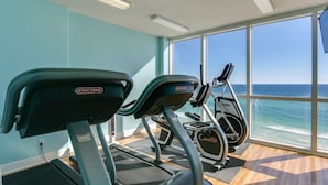 A fitness room with treadmills and a view of the ocean. - Tropic Winds 1402 (Beachfront) - Free BeachService!! (Panama City Beach)
