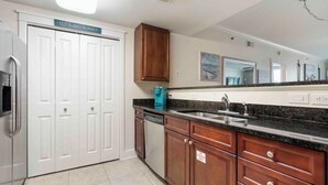 A kitchen with white cabinets, a stainless steel refrigerator, a dishwasher, and a granite countertop. - Ground floor easy access! A127 (Fort Walton Beach)