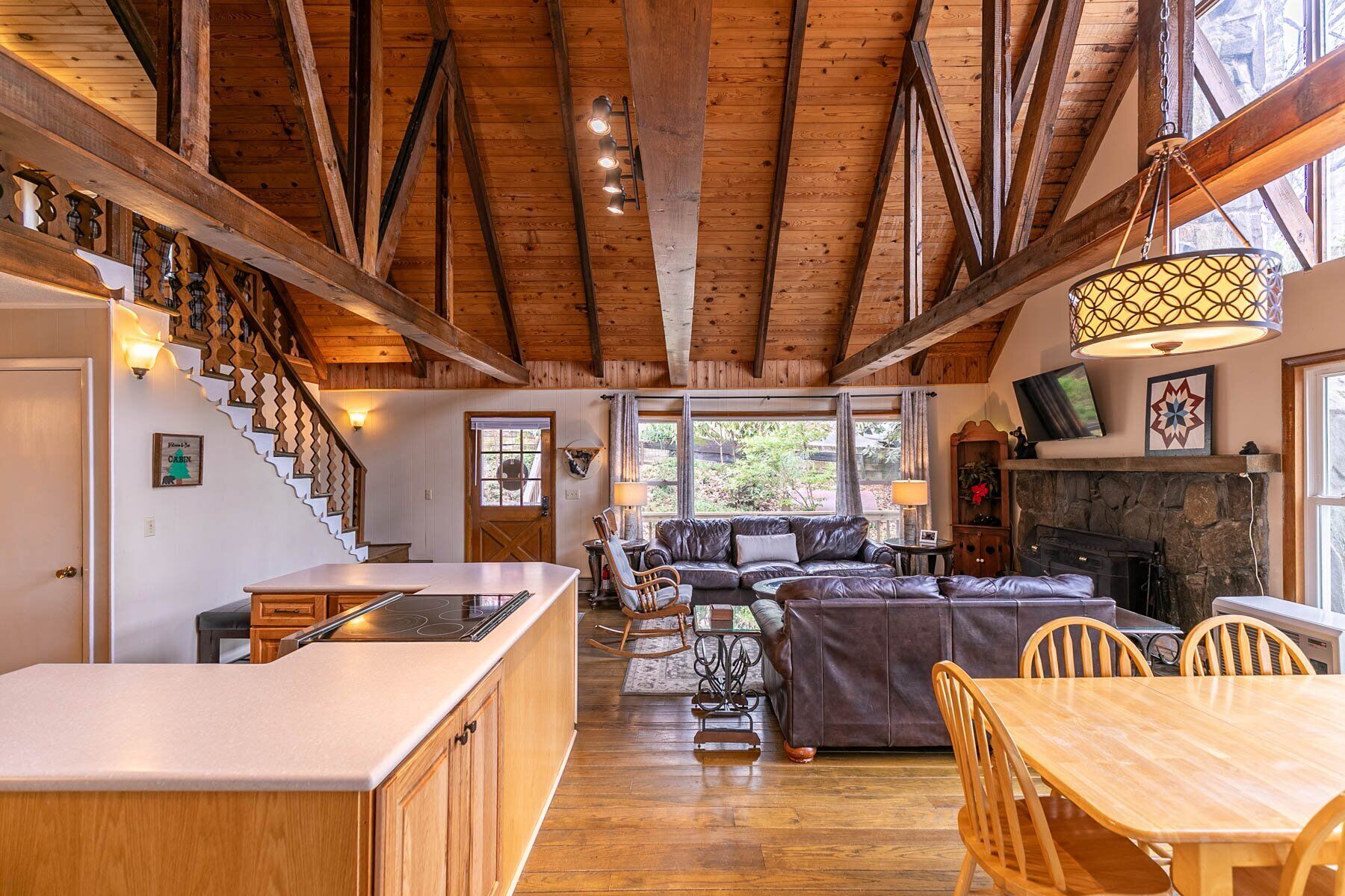 Soaring wood-beam ceilings and a stone fireplace set the tone at Bear Valley. Plenty of room for the whole group to gather.