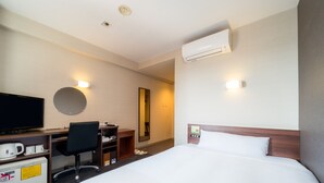 A hotel room with a bed, a desk with a chair, a television, and an air conditioning unit. - Super Hotel Ube Kosan Street (Ube)