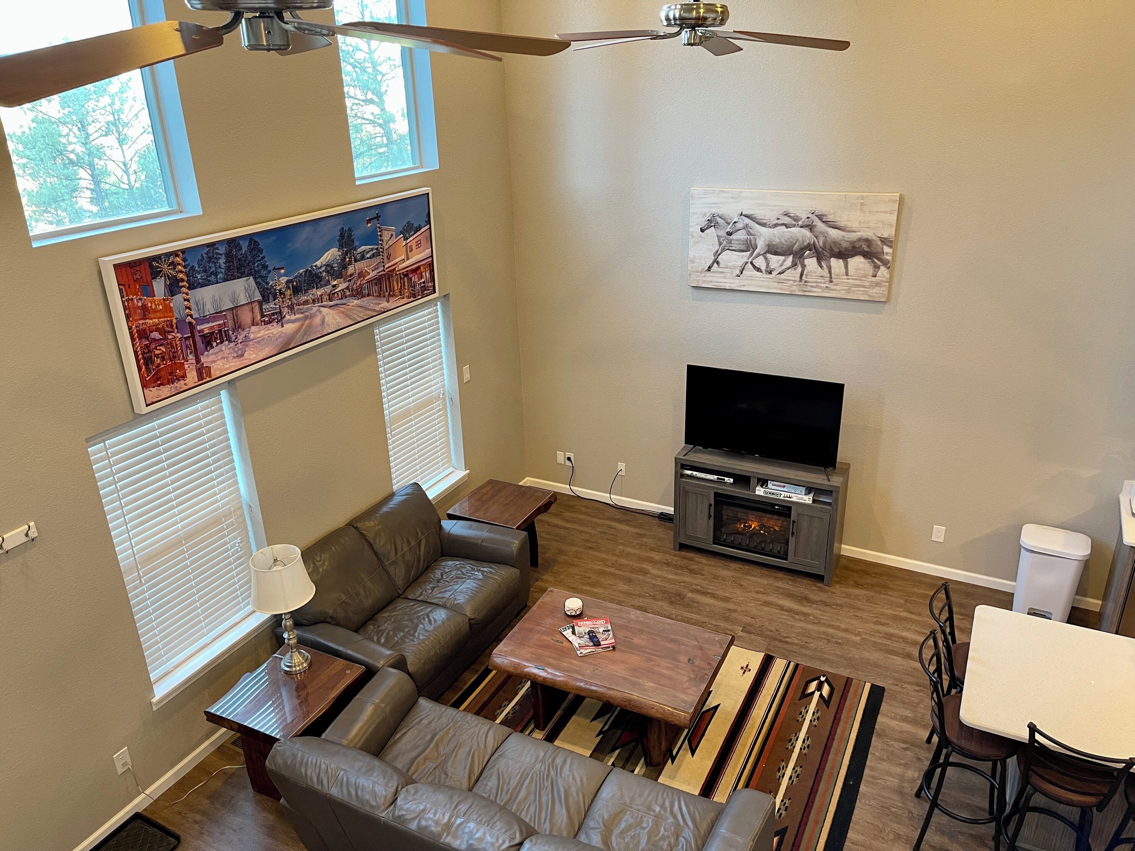 A living room with a fireplace, a television, a sofa, and a coffee table.