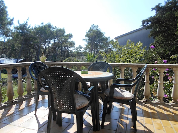 Enjoy al fresco dining on the patio, surrounded by lush trees and a charming view.