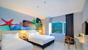 A hotel room with two beds, a large window with a view, and a mural of marine life on the wall.