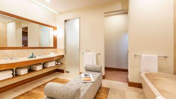 Enjoy a relaxing soak in the bathtub and unwind in the cozy seating area.