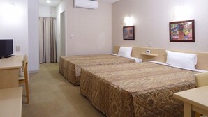 A hotel room with two beds, a desk, a chair, and a television. - Family Lodge Hatagoya Kobe Suma (Kobe)