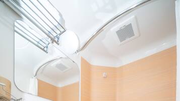 A modern bathroom with a toilet, bidet, and shower.