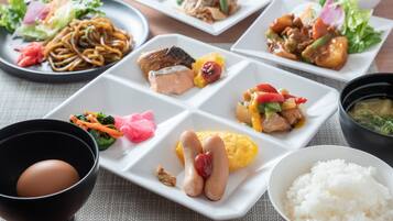 A variety of dishes on a table, including noodles, fish, and vegetables.