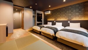 A hotel room with two beds, a wooden desk, a wardrobe, and a ceiling-mounted air conditioner. - Connect Inn Gionshijo (Kyoto)