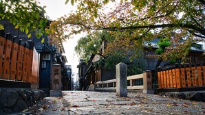 A stone pathway leading to a traditional Japanese gate with inscriptions. - Connect Inn Gionshijo (Kyoto)