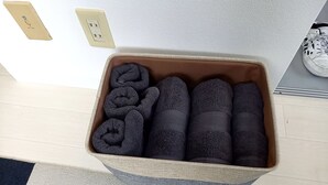 A storage bin with neatly rolled towels. - Guest house Shijo K12 (Kyoto)