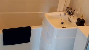 Combined shower/tub, free toiletries, hair dryer, slippers