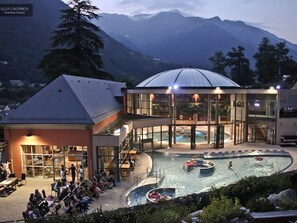 A hotel with a pool area, outdoor seating, and a mountain backdrop. - Charming 7-bedroom house in Cauterets (Cauterets)