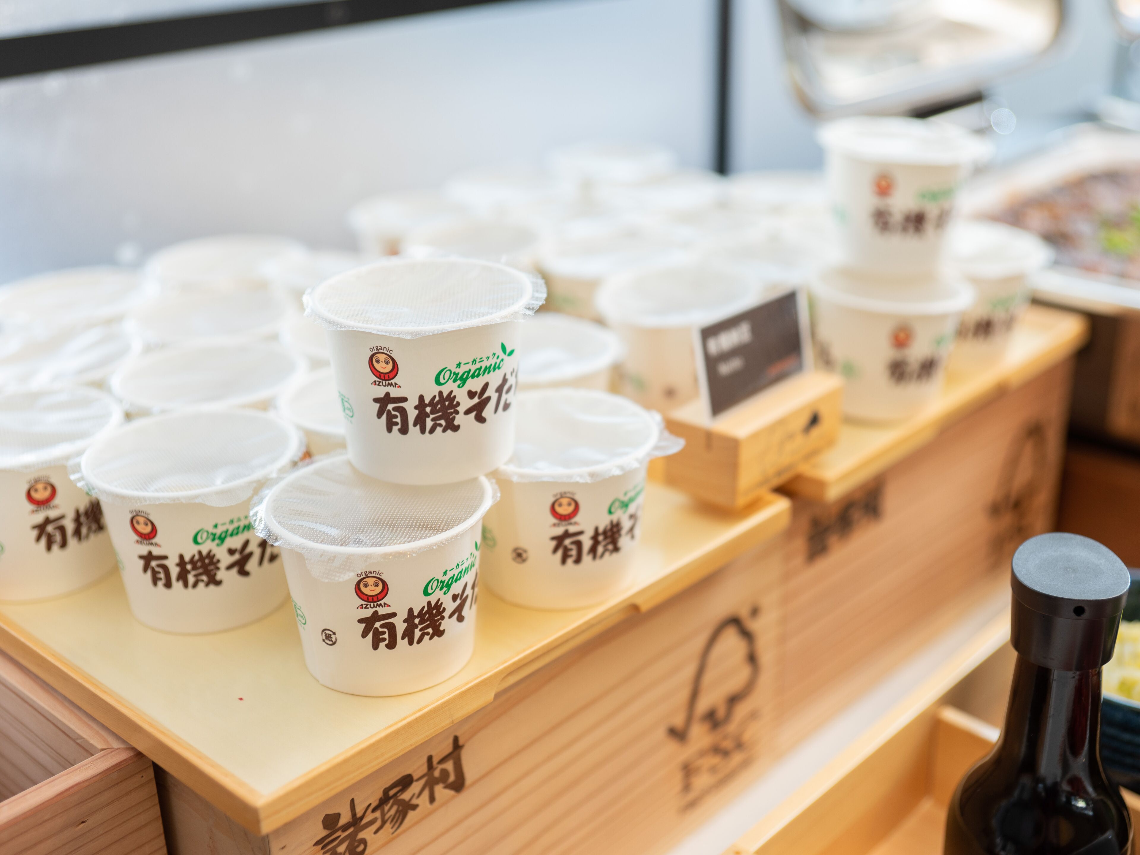 A display of organic milk cartons on a wooden shelf.
