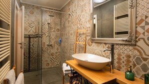 A bathroom with a large white sink, a shower, and patterned tiles. - Luxury Sea View Apartment Altana (Pula)