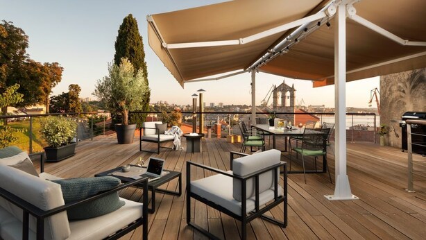 An outdoor deck with seating, a table, and a large umbrella. - Luxury Sea View Apartment Altana (Pula)