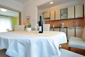 Enjoy a romantic dinner for two in this inviting dining area, complete with a round table and wine.