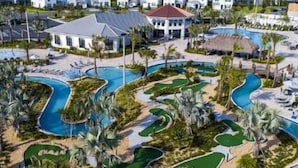 A resort with multiple swimming pools, palm trees, and a central building with a red roof. - 5Bd Home, Storey Lake with Private Pool 14 Guests - Private Pool - 2773 BD (Kissimmee)