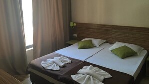 A hotel room with two beds, each with a pillow and a towel. - Flower Street Provides Accommodations With Free Wifi, air Conditioning (Nessebar)