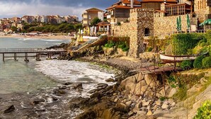 A coastal hotel with stone architecture, a beach view, and a rocky shoreline. - Flower Street Provides Accommodations With Free Wifi, air Conditioning (Nessebar)