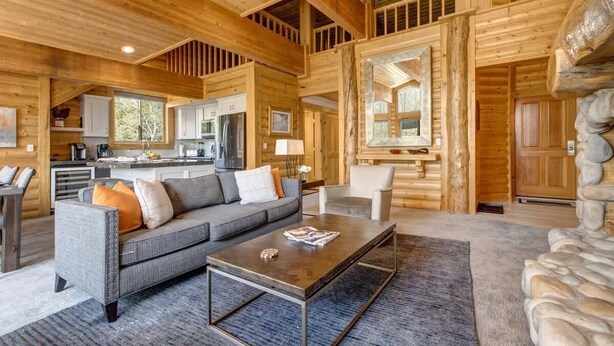A log cabin interior with a living area, kitchen, and stone fireplace. - Abode at Black Bear #431, hot tub, pool, free Main Streetreet shuttle (Park City)