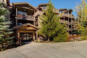 Experience the charm of the Black Bear Lodge, set amidst a serene natural setting with a rustic architectural style and wooden balconies.