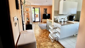 A modern kitchen with white cabinets, a coffee maker, and a TV. - Sunny island (Stari Grad)