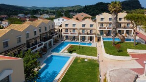 A resort with multiple swimming pools, a central courtyard, and a view of the surrounding hills. - Akron Seascape Resort by Anayia All Inclusive Resorts (Corfu)