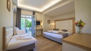 A hotel room with two beds, a desk, a TV, and a window with curtains. - Akron Seascape Resort by Anayia All Inclusive Resorts (Corfu)