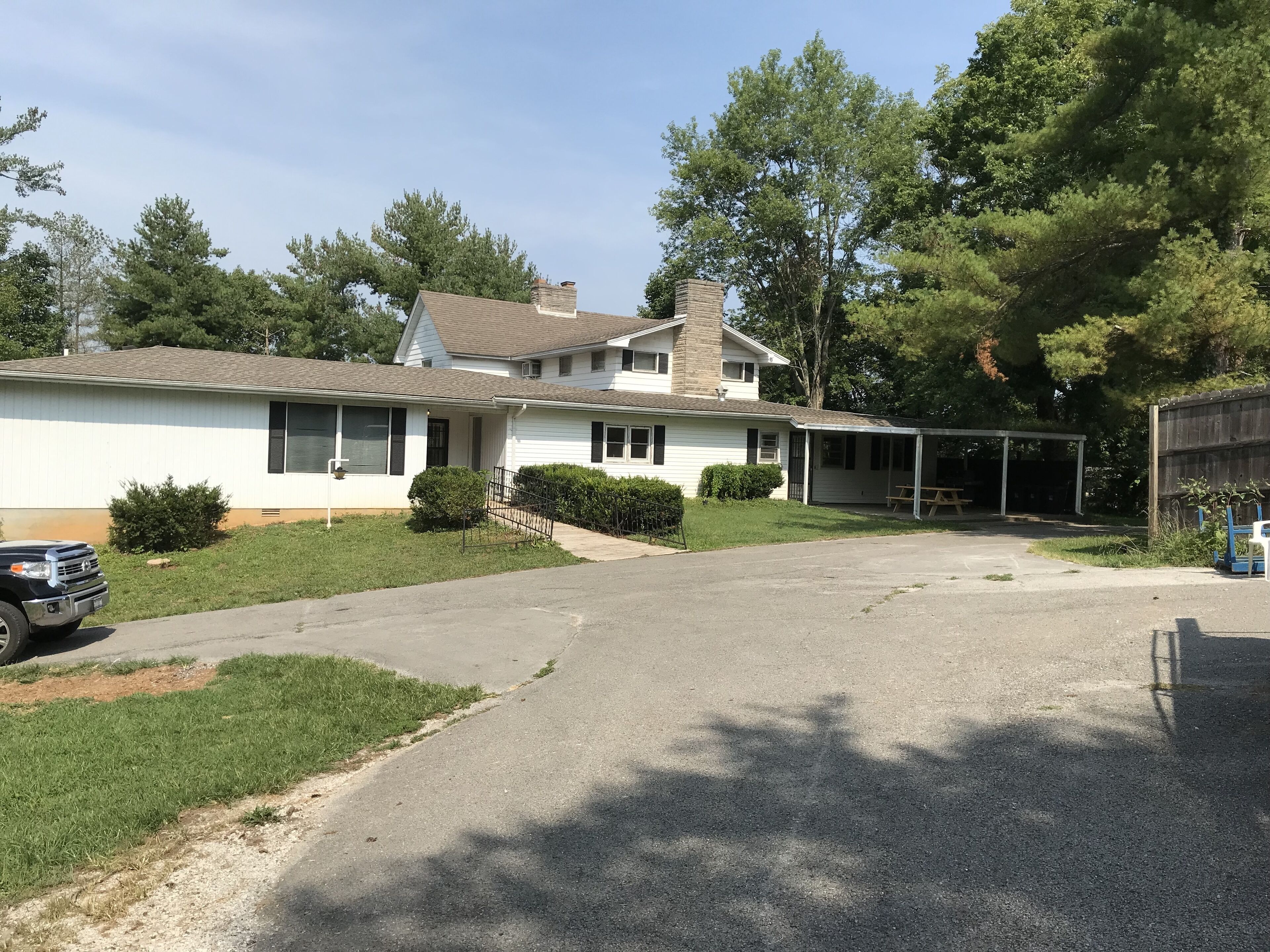 A two-story house with a covered porch and a garage.