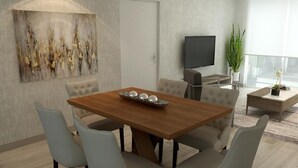 A modern dining area with a wooden table, cushioned chairs, a decorative bowl, a flat-screen TV, and a large window with a view. - Downtown Doral #504 - Studio - 5350 Park (Doral)