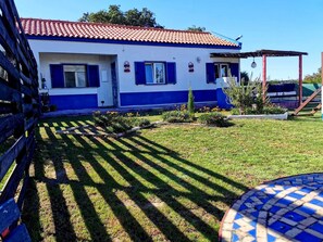 Stunning two-story residence with a beautifully manicured lawn and a charming garden.