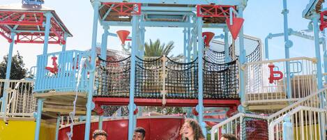 A water park with a play structure and slides.