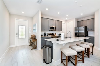Luxury Townhome, 3 Bedrooms, Golf View | Private kitchen | Fridge, microwave, oven, stovetop at Spectrum Resort Villas Orlando and Waterparks