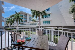 Dining for 4 outdoors on your private balcony. - House of Sun: Beachfront | VIP Perks | Bunkbeds (Sarasota)