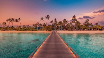 On the beach, white sand, sun loungers, beach umbrellas