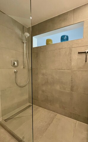 Shower, hair dryer, slippers, towels