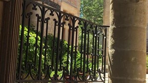 A stone building with a balcony and wrought iron railing. - Luxury apartment in a renovated Chateau with a  view of the Pyrenees. (Mouzens)